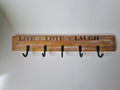 Rustic timber coat hanger laser engraved with Live Love Laugh and five black metal hooks