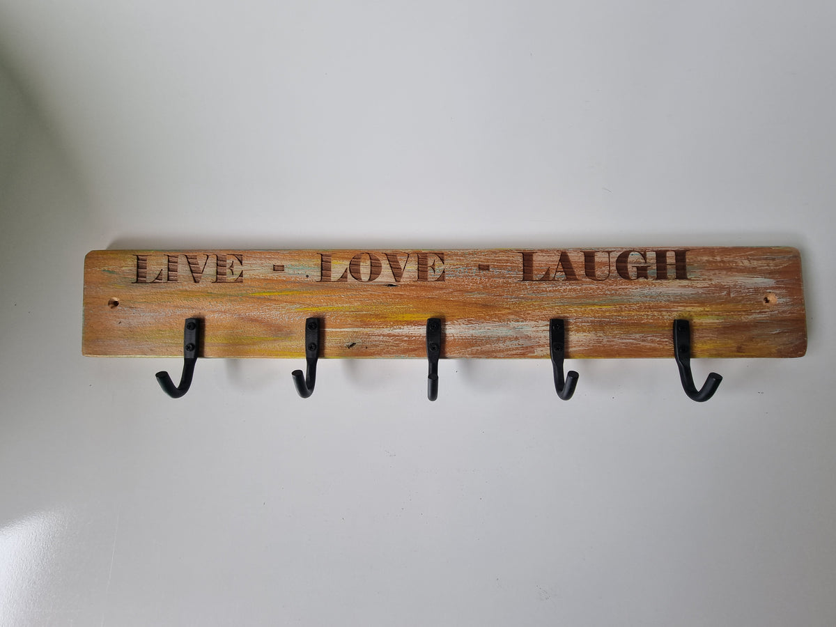 Rustic timber coat hanger laser engraved with Live Love Laugh and five black metal hooks