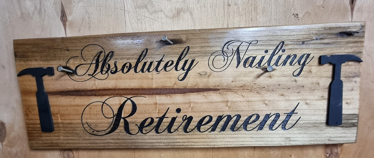 Absolutely Nailing Retirement laser engraved reclaimed timber sign with plywood hammer icons